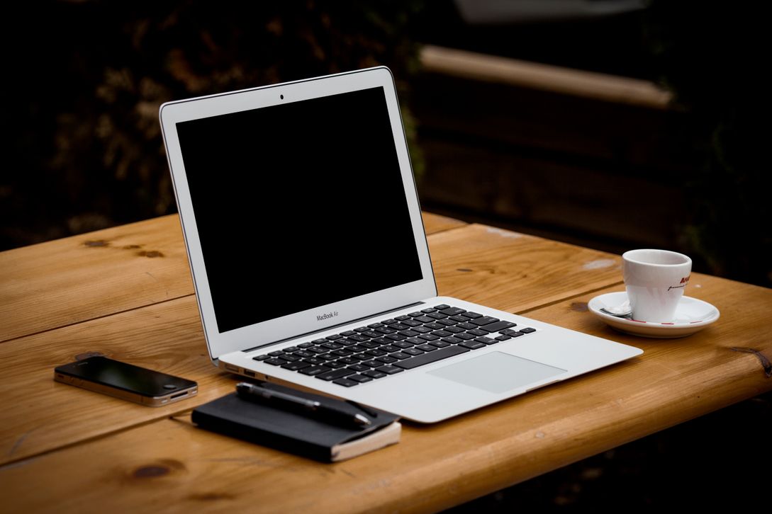 A MacBook pro placed on a wooden table.